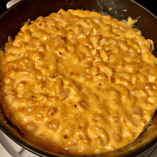 A mouthwatering image of a bubbling Dutch oven mac and cheese, with golden brown cheese on top.